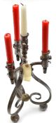 A steel candelabrum, formed from 3 complete mid 19th century continental socket bayonets curled at