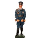 A Lineol figure of Herman Goring. Standing in full dress uniform and peaked cap holding his baton.