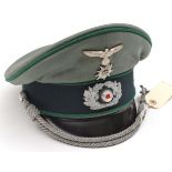 A Third Reich Mountain Troop army officer’s peaked cap, of light field grey cloth with black band,