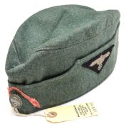 A Third Reich SS sidecap, with embroidered SS eagle on left side, and single white metal death’s