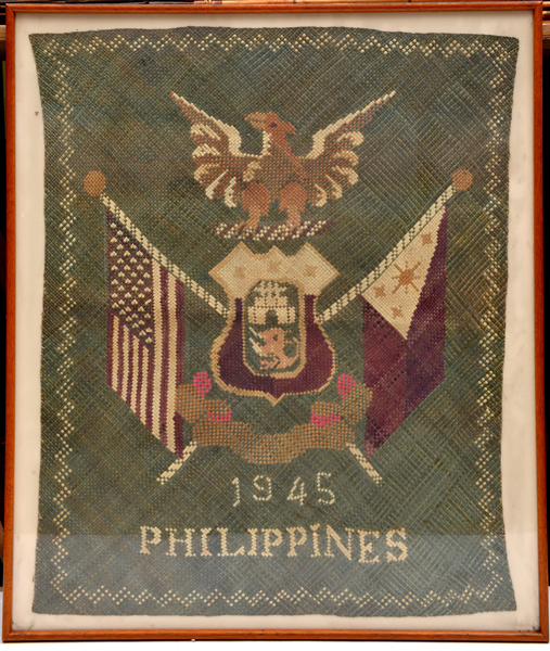 A WWII woven coloured raffia panel to celebrate the Liberation of the Philippine Islands, 1945,