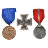 A Third Reich SS 8 year service medal, in silver; an Iron Cross 1st Class; a Russian Front medal