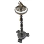 An alloy ashtray/matchbox holder, of HMS Hermes, on turned darkwood stem and pedestal base, the