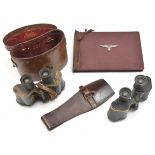 A prismatic binocular, approx 8 x 35, individual eyepiece focus, in leather case, both with WD broad
