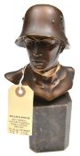 A bronzed spelter bust of a Third Reich soldier, head and shoulders, wearing a double decal steel