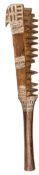 A 19th century Oceanic Islands brown wood paddle club, of flattened diamond section, the head with