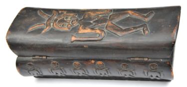 An African curved darkwood box, the lid with large stylized figure, lines of small similar figures