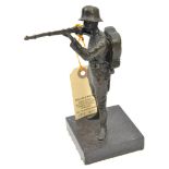 A bronzed figure of a WWI Imperial German infantryman taking aim, 7¼” on a rectangular base 3” x 3”.