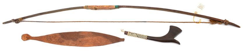 A Pacific darkwood bow, decorated on inner side with name “Suva”, 50”; an Australian spear thrower