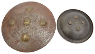 A small Benares brass shield, turn over rim, 4 central bosses, foliate panel decoration overall,