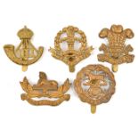 4 WWI all brass cap badges: Hampshire, Welsh, Middlesex and DLI; a Gloucester officer’s lapel. GC to