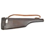 A ‘leg o mutton’ leather gun case, with brass hasp, leather carrying strap. GC