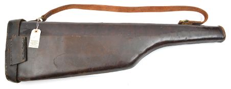 A ‘leg o mutton’ leather gun case, with brass hasp, leather carrying strap. GC