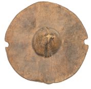 A very good Sudanese circular elephant hide shield, with prominent conical central boss, wooden grip