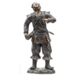 A Japanese bronzed brass, plaster filled figure of an archer, bareheaded, wearing ornamental lightly