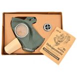 A Third Reich civilian gas mask in its original cardboard carton, “Die Deutsche Volksgasmask”