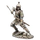 An impressive spelter figure of a Japanese Samurai warrior in full armour, carrying a katana and