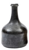An early 18th century mallet shape wine bottle, of dark green glass, deep punt to base, 6½” overall,