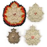 4 Border Regt cap badges: Vic (brooch pin), larger KC (2), one on black/red/yellow rosette, and