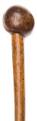 A Zulu walking stick/knobkerry, of polished light brown wood, the stout stem of slightly tapered