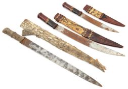 A bazaar quality Sudanese dagger, in crocodile skin sheath, and 2 similar W African daggers in brown