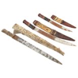 A bazaar quality Sudanese dagger, in crocodile skin sheath, and 2 similar W African daggers in brown