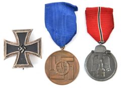 A Third Reich East Front medal, with ribbon; also a 1939 Iron Cross 1st class, of one piece non