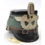 A Third Reich Police shako, field grey body, black patent finish top and peaks, alloy mounts. Marked