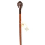 A Zulu walking stick, polished brown wood haft slightly tapered towards the lower end, 2 tone