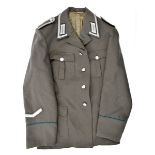 A post war East German officer’s tunic, with “Grenztruppen Der DDR” cuff title and matching