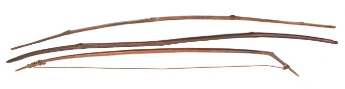 3 old dark wood bows, length 53”, 57” and 59”, the first complete with drawstring. GC