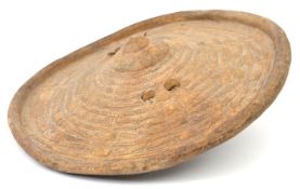 A small 19th century Somali circular hide shield, turn over rim, the centre with simple panelled