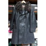A heavy ¾ length black leather coat, with plain black buttons, sheepskin collar and felt lining, the