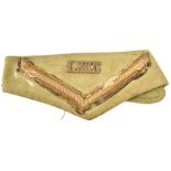 A WWII brass LRDG title, on its original lance corporal’s khaki arm band (chevron worn). GC