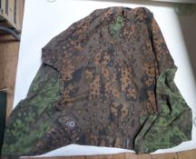 A scarce Third Reich SS Zeltbahn, of spring and autumn reversible woodland pattern, complete with