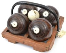 4 darkwood bowling woods, numbered 1,3,5 and 7, size 5-1/8, in their wooden tray with iron