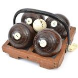 4 darkwood bowling woods, numbered 1,3,5 and 7, size 5-1/8, in their wooden tray with iron