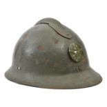 A French “Adrian” pattern steel helmet, stamped disc with “RF” grenade on crossed cannon, leather