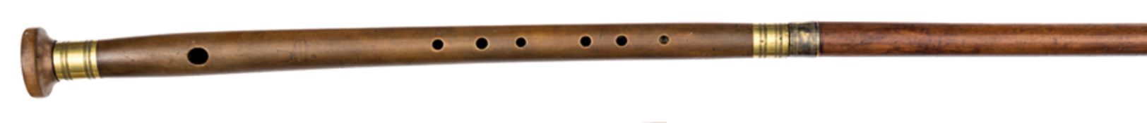 An early 19th century walking cane flute, of darkened bamboo, with plain line turned silver plated