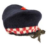 A Crimean War period OR’s coarse blue cloth glengarry, diced red and white headband, small red