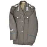 A post war German NCO’s tunic, light grey with silver collar patches, epaulettes, etc; also 8