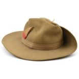 A WWII khaki felt slouch hat, plain 1” headband, yellow/red base triangle badge (loose), silver