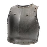 An early 19th century French steel breastplate, with border of domed brass rivets and two domed