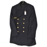 A German Navy double breasted blue deck coat, gilt anchor buttons and bronze finish breast badge.