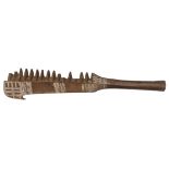 A 19th century Oceanic Islands brown wood paddle club, of flattened diamond section, the head with