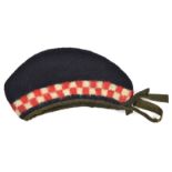 A Crimean War period OR’s coarse blue cloth glengarry, diced red and white headband, small red