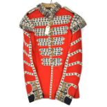 A Coldstream Guards bandsman’s scarlet tunic, heavily laced, brass regimental buttons and bandsman’s
