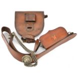 A brown leather shoulder belt and pouch, with WM lion’s head boss, whistle and chains (belt and