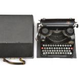 A German Third Reich period Groma Modell II portable typewriter, the keyboard incorporating a key