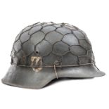 A Third Reich M42 single decal SS helmet, the rough black painted skull having maker’s code “hkp” (